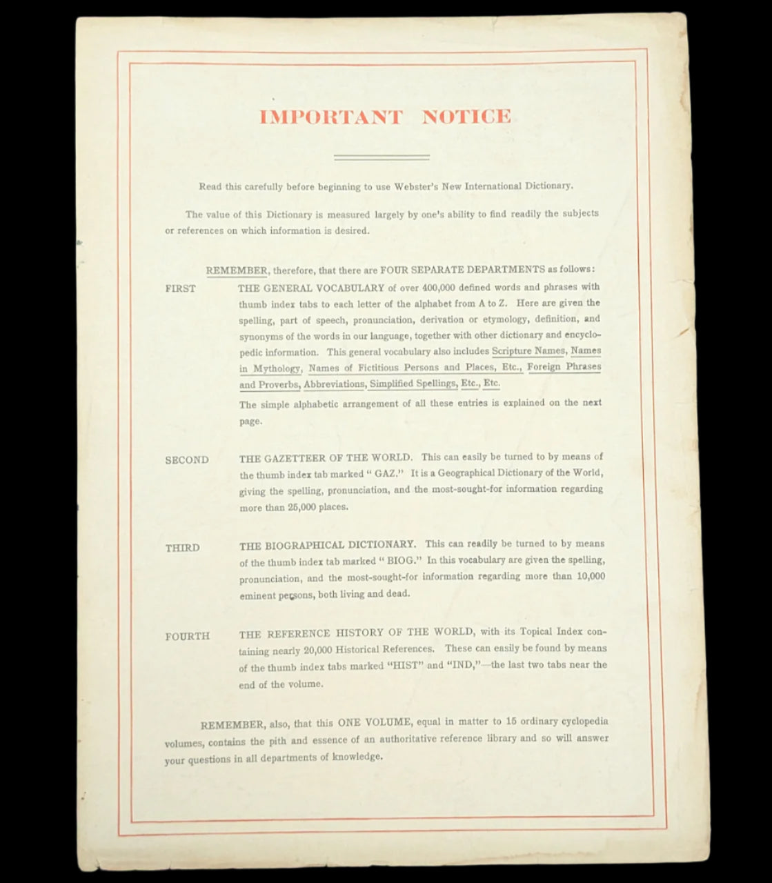 Important notice page from Webster's New International Dictionary on a dark background