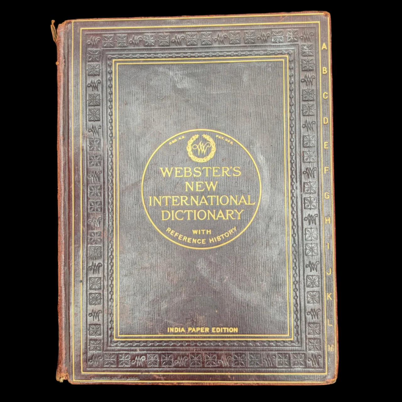 Vintage Webster's New International Dictionary on a dark background