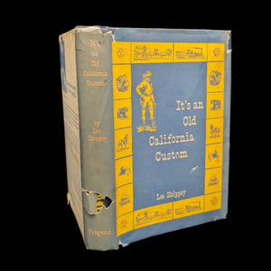 A hardcover book titled 'It's An Old California Custom' by Lee Shippey with a blue and yellow cover, showing signs of wear and age.