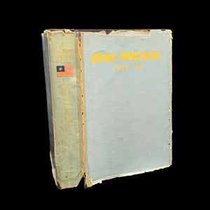 A worn hardcover book titled 'China Handbook, China Yearbook, 1953-1954' with a green and yellow cover.
