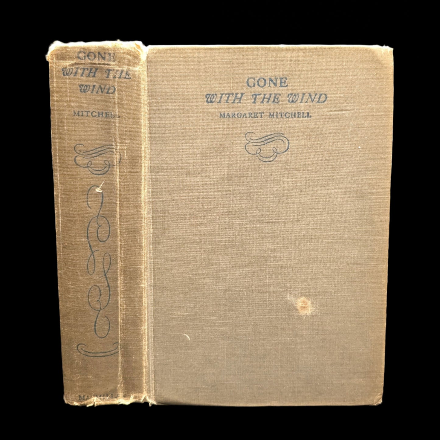 A hardcover edition of the book 'Gone With The Wind' by Margaret Mitchell with visible wear on the cover.