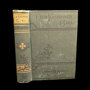 Cover of the book 'An Old Fashioned Girl, 1910' by Louisa M Alcott, showing the title and author's name, with decorative floral patterns.