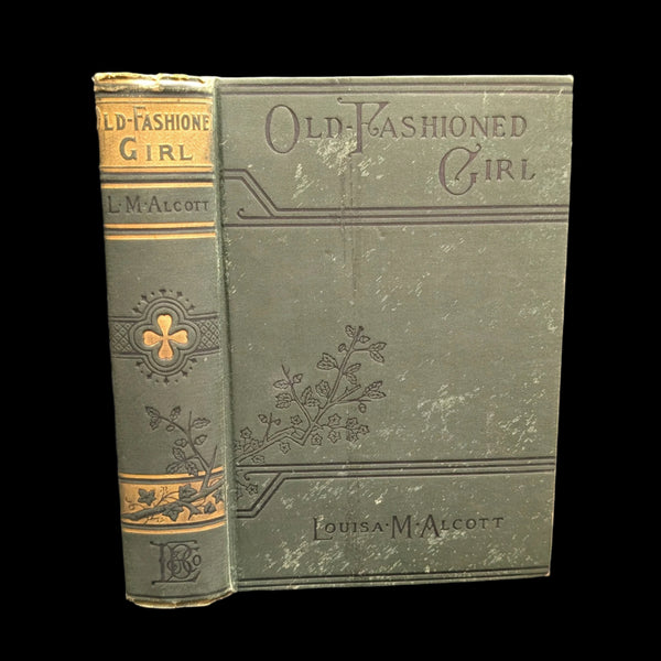 Cover of the book 'An Old Fashioned Girl, 1910' by Louisa M Alcott, showing the title and author's name, with decorative floral patterns.