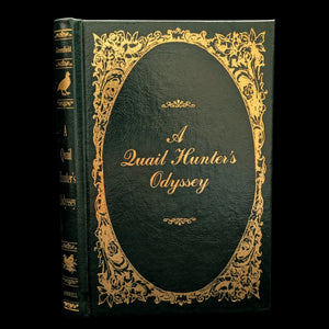 A hardcover edition of 'A Quail Hunter's Odyssey' with a black and gold cover design, including ornate gold detailing around the text.