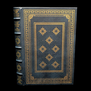 A signed first edition book titled 'The Penitent' by Isaac Bashevis Singer, featuring a black leather cover with gold embossed decorations.
