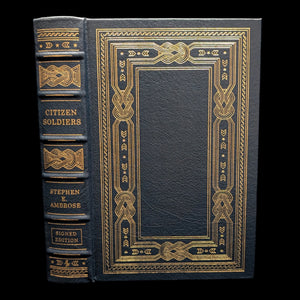 A leather-bound collector's edition book titled 'Citizen Soldiers' by Stephen E. Ambrose, featuring gold embossed decorations and the title on the cover.