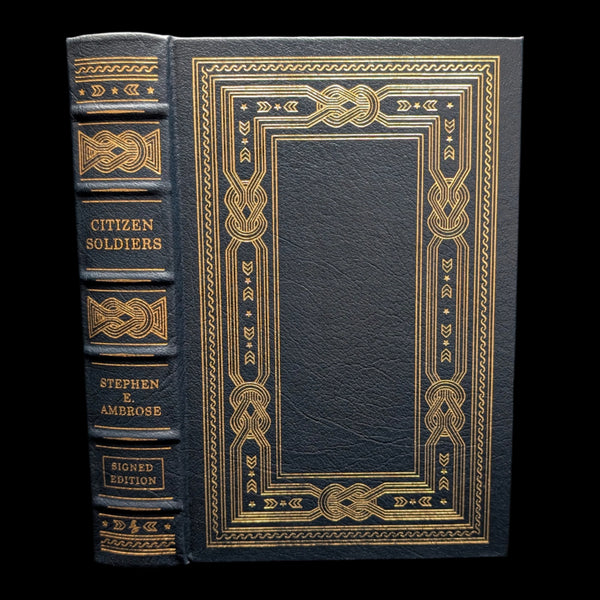 A leather-bound collector's edition book titled 'Citizen Soldiers' by Stephen E. Ambrose, featuring gold embossed decorations and the title on the cover.