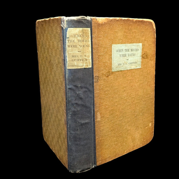 Antique book titled 'When The Movies Were Young' with a visible signature on the cover, housed in a bookshelf.