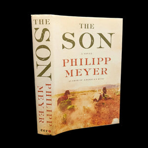 The Son, A Novel by Philipp Meyer, with a dust jacket featuring an image of horses and riders on a dusty plain.