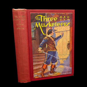 Cover of 'The Three Musketeers' book featuring an illustration of a man in historical costume holding a sword, with the title and author's name printed below.