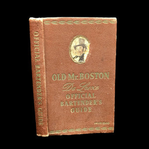 A hardcover book titled 'Old Mr. Boston Official Bartender's Guide' with a worn brown cover and a portrait of a man in a hat on the cover.