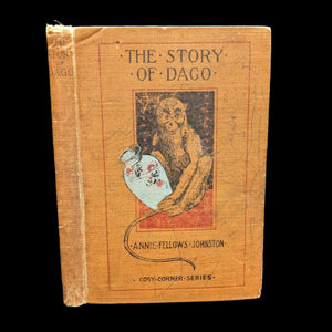 The image displays an old book titled "The Story of Dago" by Annie Fellows Johnston, published in 1900 as part of the Cozy Corner Series. The book's cover features a monkey design, adding a whimsical touch to the vintage aesthetic.