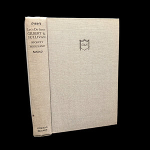 A book titled 'Let's Do Some, Gilbert & Sullivan' with a dust jacket and the name 'Edmond Rickett' visible on the cover.