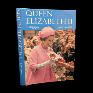 A cover photo of the book 'Queen Elizabeth II A Biography' by Judith Campbell featuring a photograph of Queen Elizabeth II in a pink dress and hat, holding a bouquet.