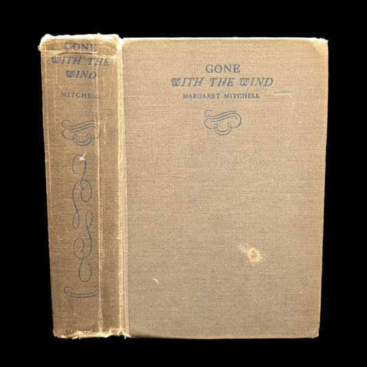 A hardcover edition of the book 'Gone With The Wind' by Margaret Mitchell with visible wear on the cover.