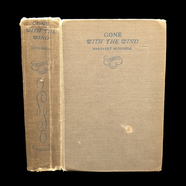 A hardcover edition of the book 'Gone With The Wind' by Margaret Mitchell with visible wear on the cover.