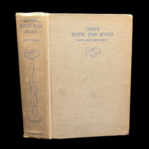 A hardcover edition of the book 'Gone With The Wind' by Margaret Mitchell with a brown paper cover featuring the title and author's name.