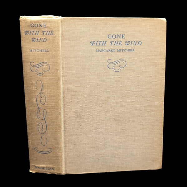 A hardcover edition of the book 'Gone With The Wind' by Margaret Mitchell with a brown paper cover featuring the title and author's name.