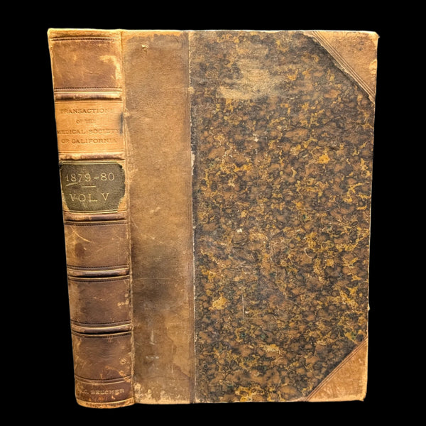 An old, leather-bound book with visible wear, titled 'Transactions of the Medical Society of the State of California, 1879, 1880'.