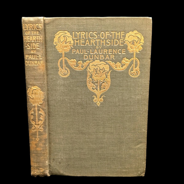 Cover of the book 'Lyrics Of The Hearthside' by Paul Laurence Dunbar, featuring decorative floral motifs and the author's name in elegant typography.