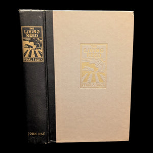 A hardcover edition of 'The Living Reed' by Pearl S. Buck, with visible signs of wear.