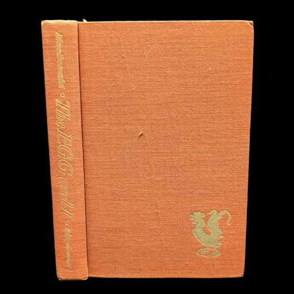 A hardcover book titled 'The Egg And I' by Betty MacDonald with a beige cover featuring a title and author's name, along with a small decorative element.