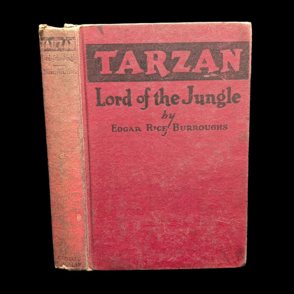 The cover of the book 'Tarzan: Lord of the Jungle' by Edgar Rice Burroughs, featuring a red background with black text.