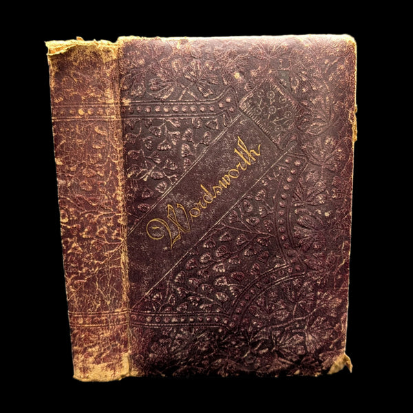 An old hardcover book with a worn brown cover featuring ornate patterns and the title 'Wordsworth' printed on it.