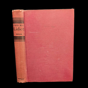 A hardcover book with a red and orange dust jacket. The title 'This Was Lidice' by Gustav Holm is visible on the spine.
