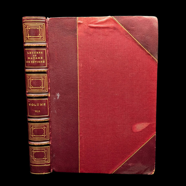 A hardcover book with a red and gold binding, titled 'Volume VII', indicating it is part of a series.