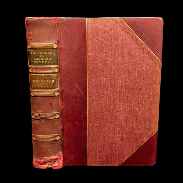 An old hardcover book titled 'The Ordeal of Richard Feverel, 1905' with a red and gold book cover.