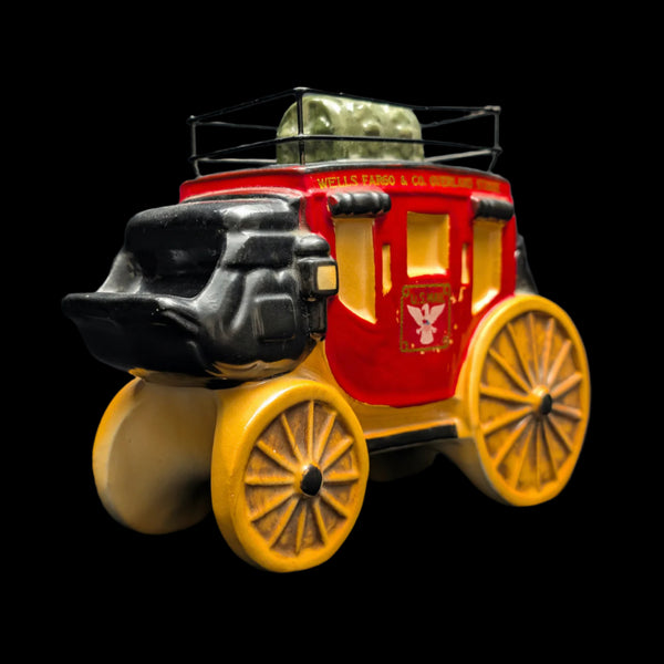A ceramic vintage Wells Fargo Stagecoach coin bank with a vibrant red body, detailed gold accents, and the iconic Wells Fargo logo.