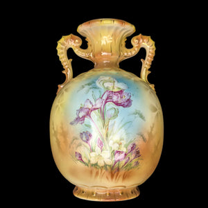 A tall Austrian porcelain vase with a buttery yellow hue and hand-painted floral design, featuring ornate handles.