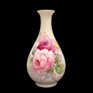 A vintage Noritake porcelain vase with a floral pattern, predominantly pink roses, against a black background.