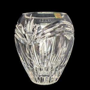 A clear crystal vase with intricate cut designs, featuring a geometric pattern that creates a dazzling display of light and sparkle.