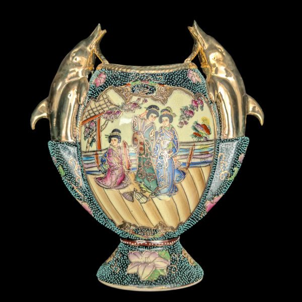 A vintage Royal Satsuma decorative vase featuring hand-painted scenes with elegant women, gilded dolphin handles, and intricate gold detailing.