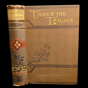 Cover of the book 'Under The Lilacs' by Louisa M. Alcott, featuring illustrations and the title printed on the front and back cover.