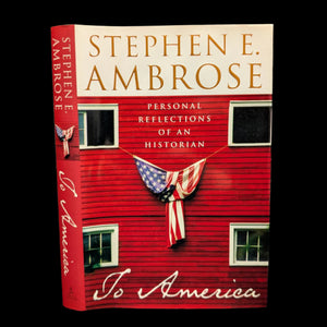 The cover of the book 'To America' by Stephen E. Ambrose features a red wooden house with an American flag, indicating a patriotic theme.